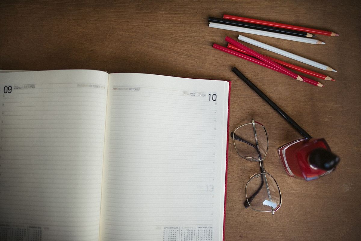 A desk with an open notebook and pencils, standing in for the slow, written reasoning AI decision support is meant to assist rather than replace.